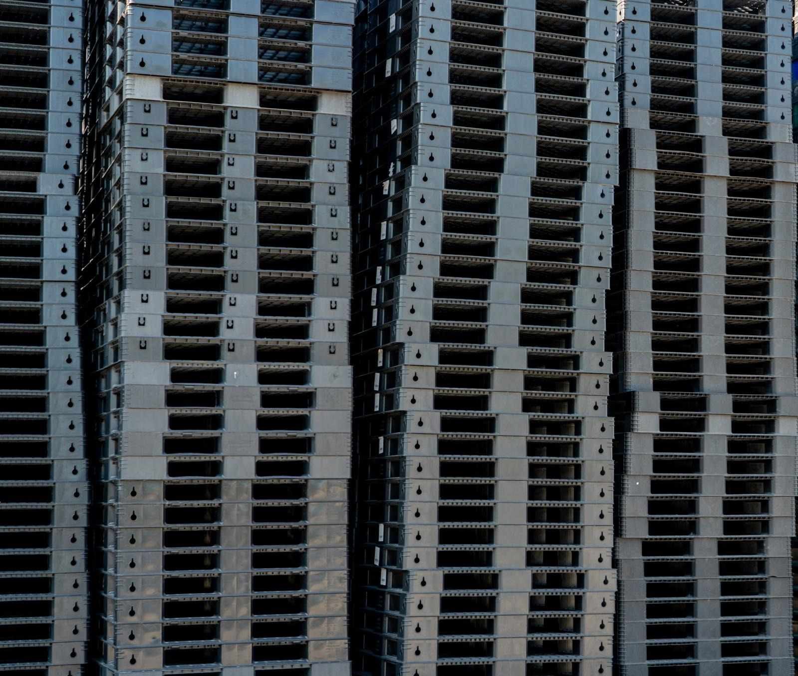 Large stock of black plastic pallets